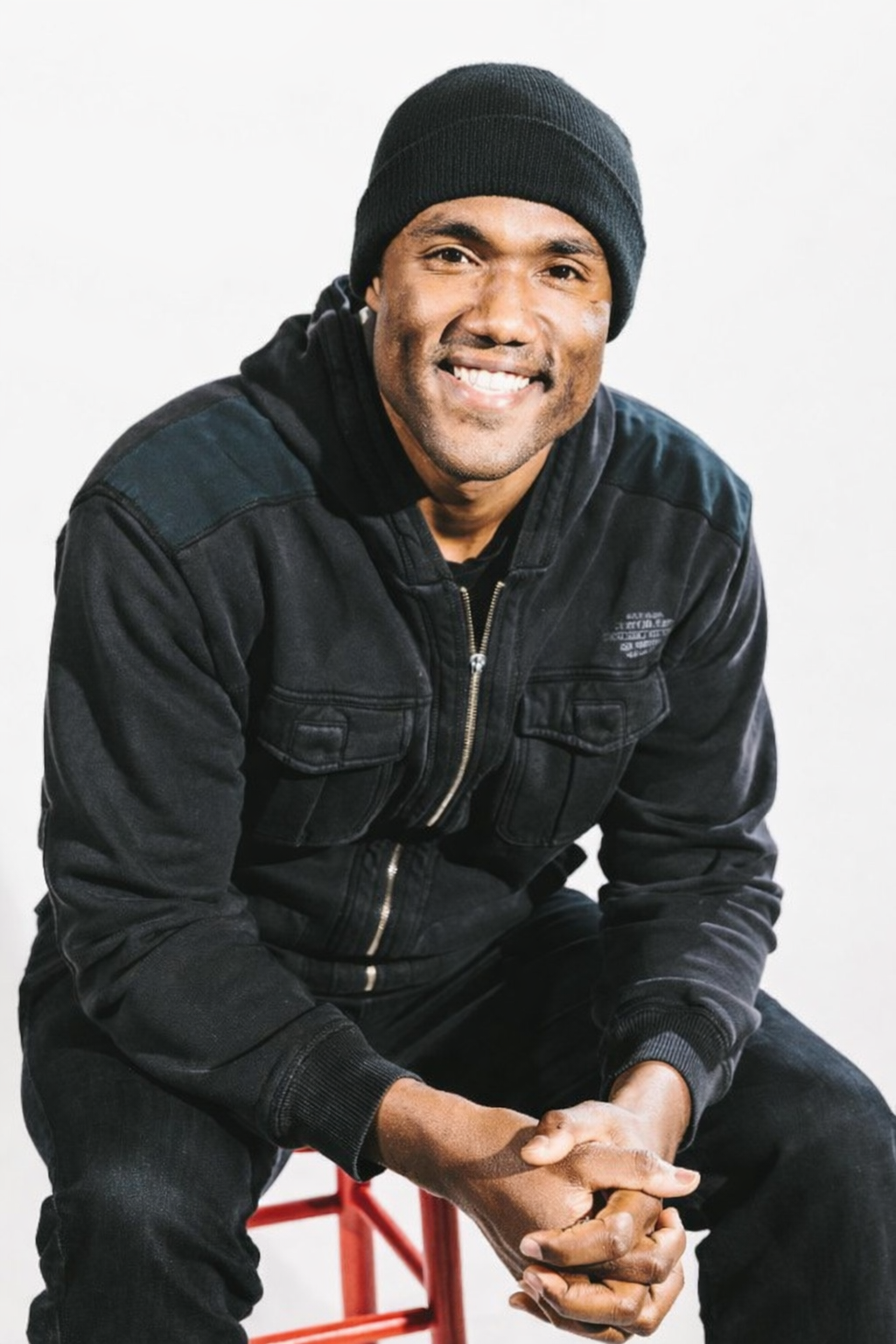 George Foreman III seated on a corner stool
